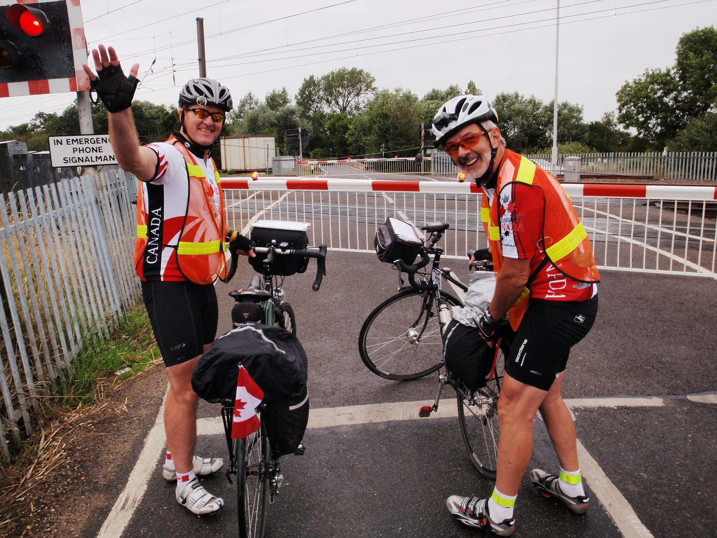 Canadian riders at railway crossing gate