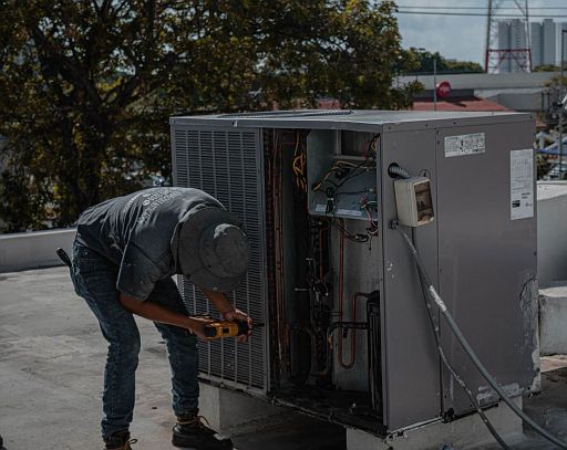 Filters - Technician repairing an HVAC unit